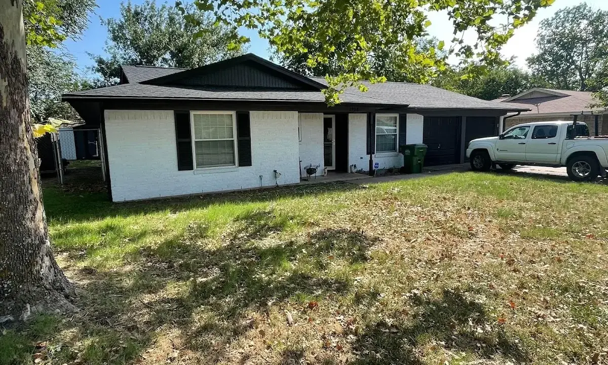 Professional roofing crew working on a residential roof in Woodbury